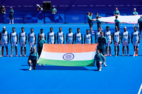 India's players stand for the national anthems before the men's bronze medal field hockey